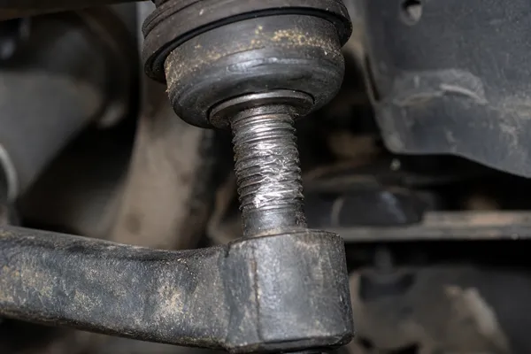 Galled threads on sway bar link from insufficient torque Sway bar link threads showing galling from loose installation