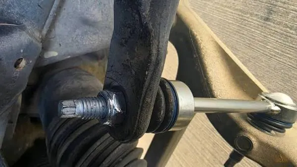 Cracked nylon locking insert in sway bar link nut from over torque Returned sway bar link nut showing cracked nylon insert from over-torque