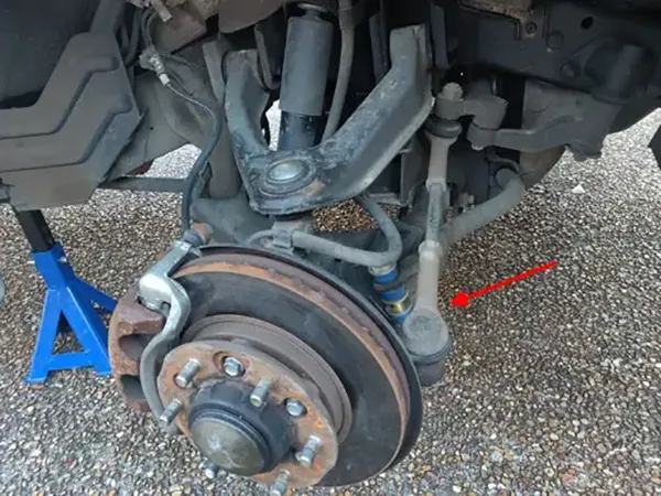 Aftermarket tie rod with measuring calipers next to old tie rod
