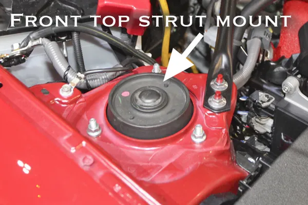 Inside the strut mount metal forming and bonded interface inside an aftermarket strut mount